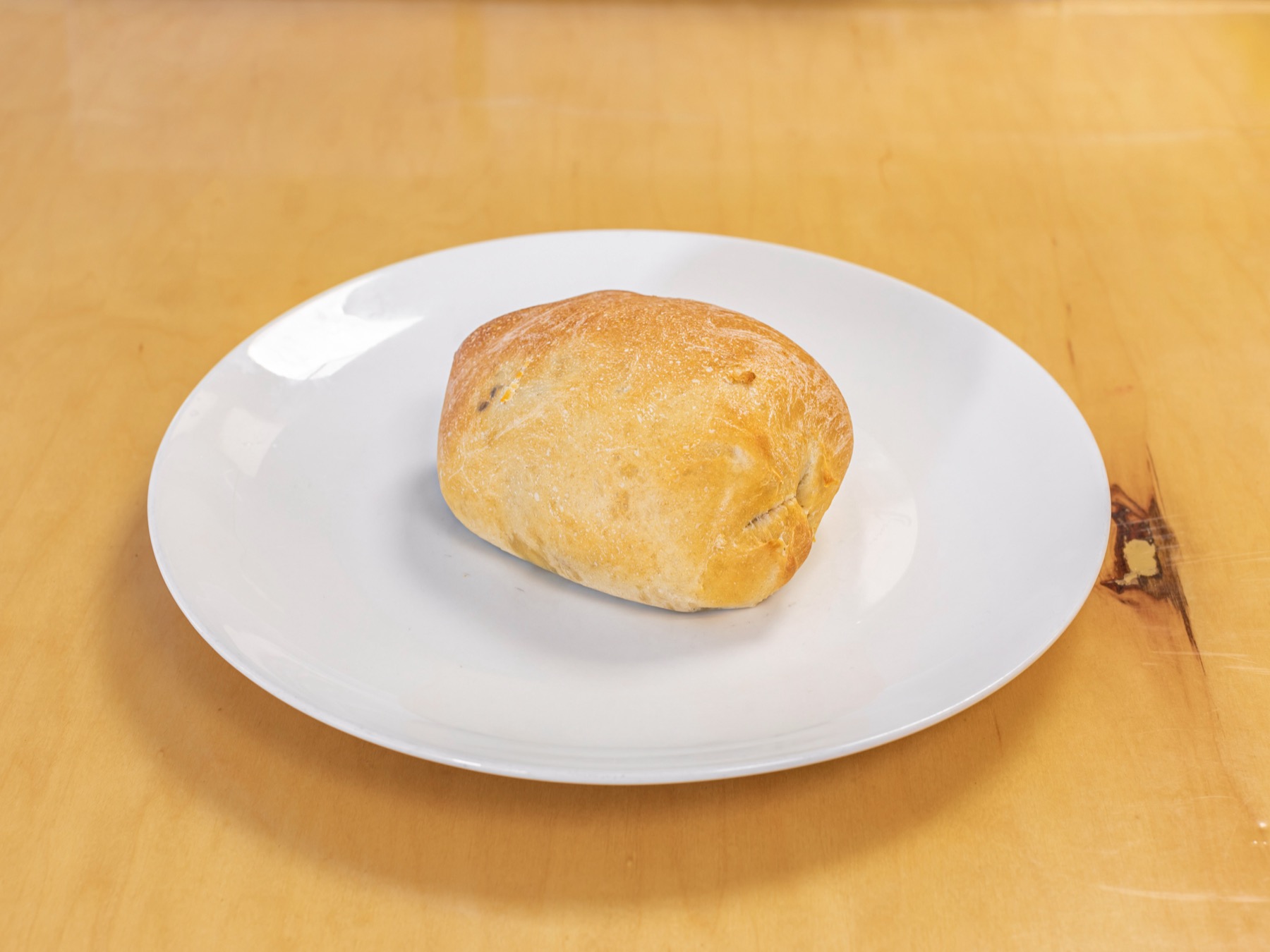 Beef Pie, a closed baked pie on a white plate