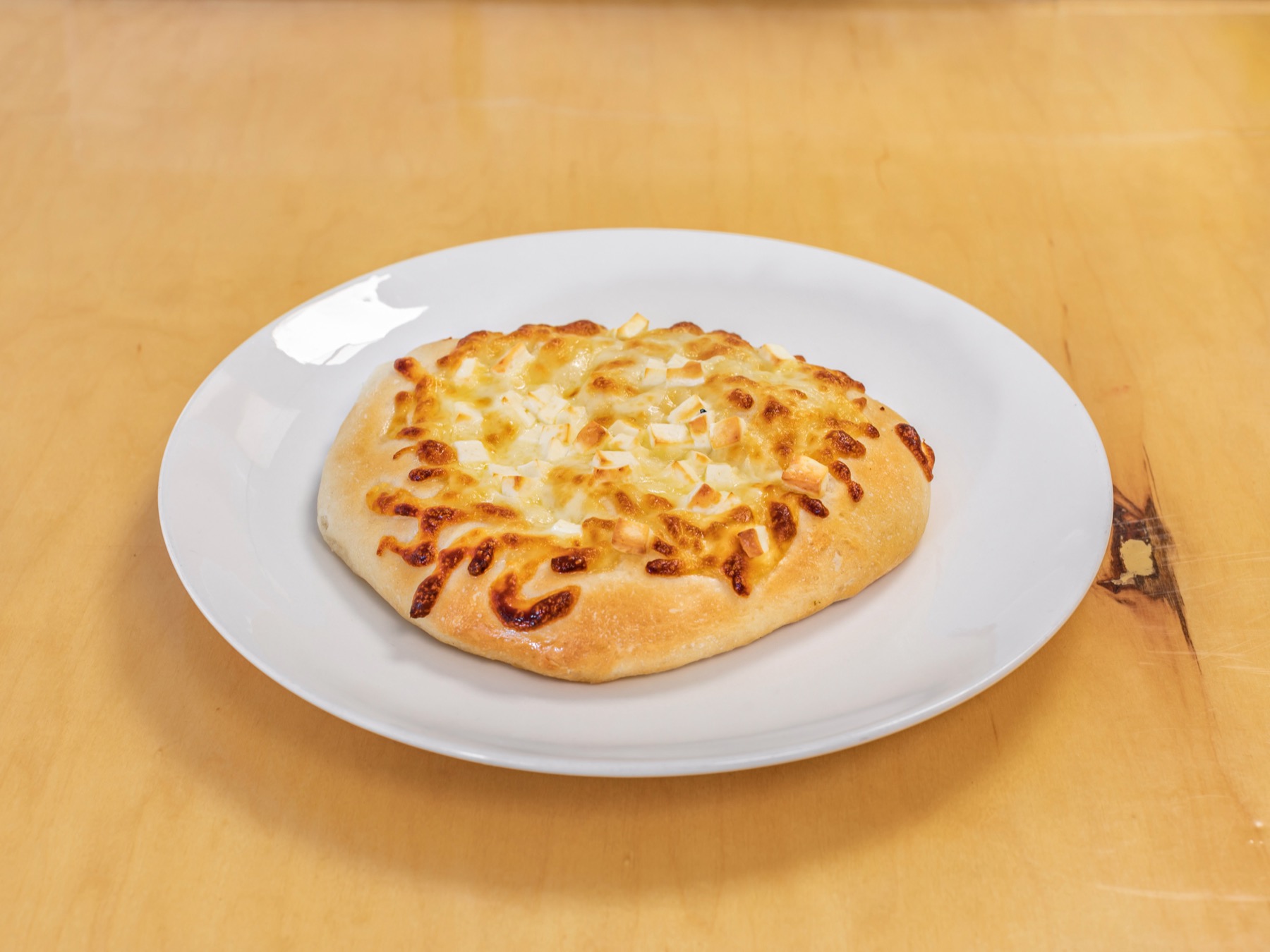 Cheese Pie, open-faced with melted mozzarella and Nabulsi cheese