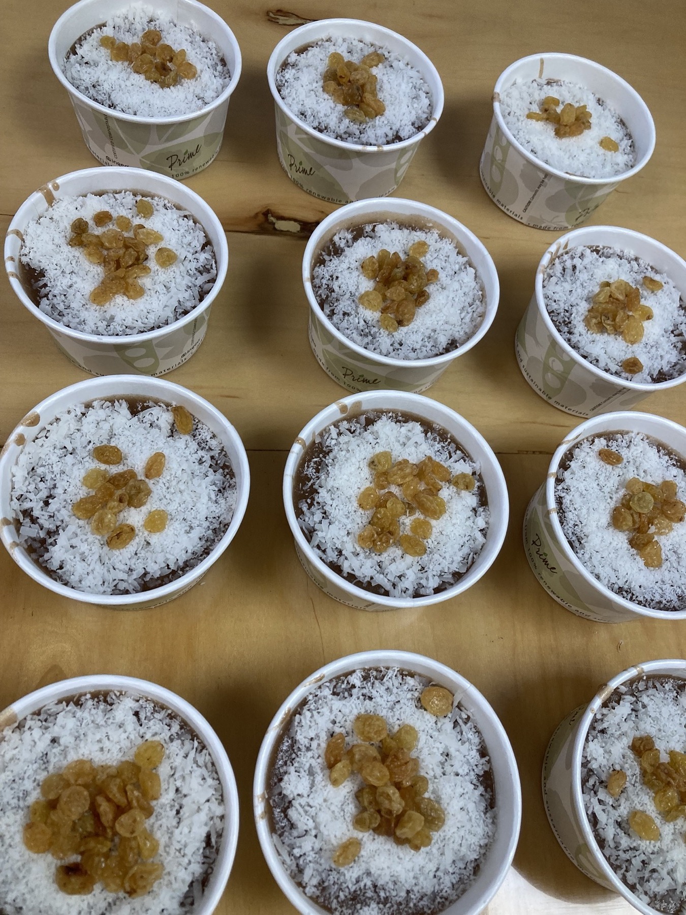 Cups of Mughli, cinnamon and caraway pudding topped with coconut and raisins